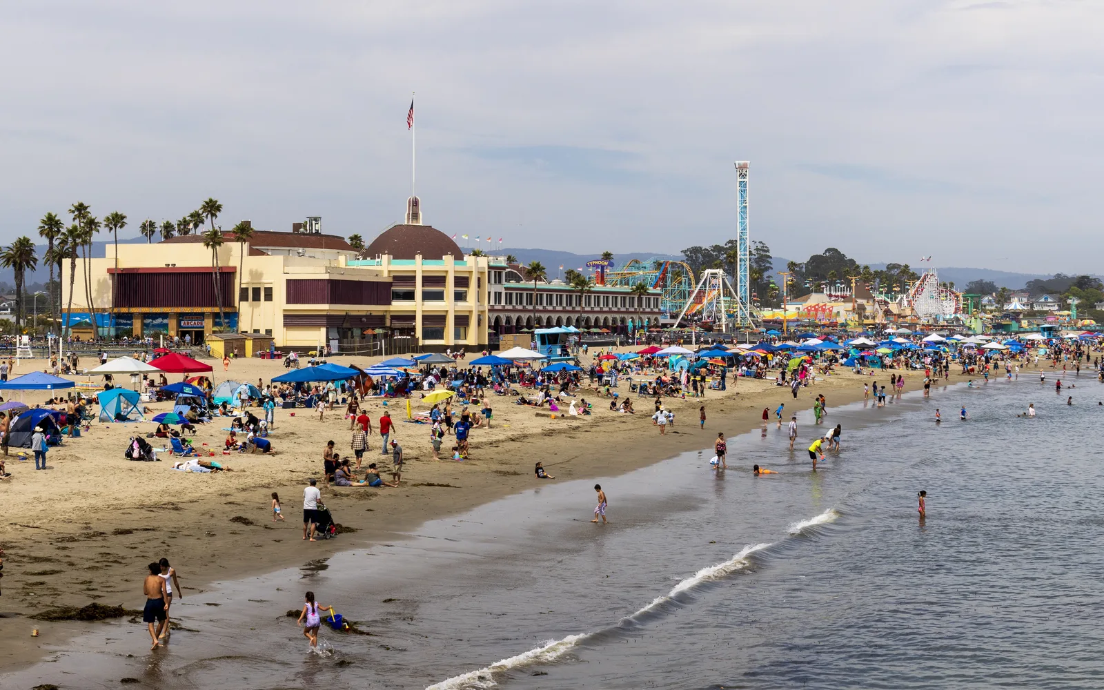 View of the Santa Cruz Beach Boardwalk along the coast, showing amusement park attractions and the beach